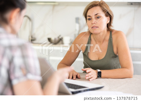 Woman manager tells girl client about specifics of design of microloan about benefits and advantages Woman manager tells girl client about specifics of design of microloan about benefits and advantages 137878715