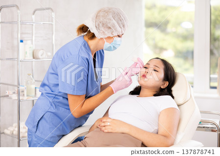 Doctor doing anti-aging beauty procedures Doctor doing anti-aging beauty procedures 137878741