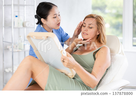 Blonde european women listening to professional medicine worker Blonde european women listening to professional medicine worker 137878800