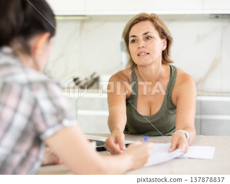 Woman manager tells girl client about specifics of design of microloan about benefits and advantages Woman manager tells girl client about specifics of design of microloan about benefits and advantages 137878837