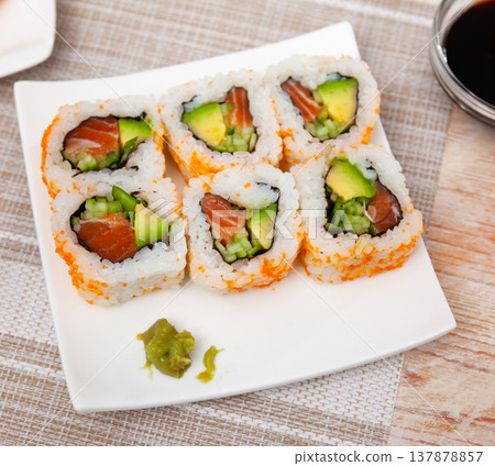 Set of uramaki rolls with salmon, avoado and cucumber closeup Set of uramaki rolls with salmon, avoado and cucumber closeup 137878857