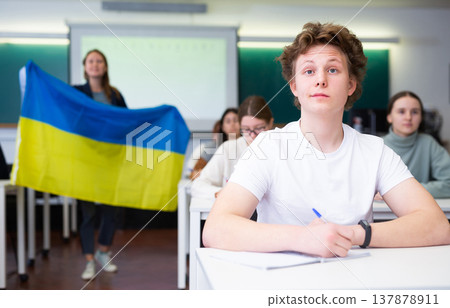Young boy student studying diligently at school Young boy student studying diligently at school 137878911