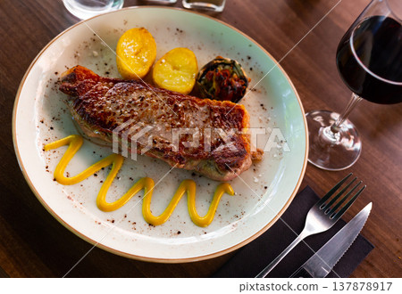 Fried beef meat with boiled potatoes and vegetables closeup Fried beef meat with boiled potatoes and vegetables closeup 137878917