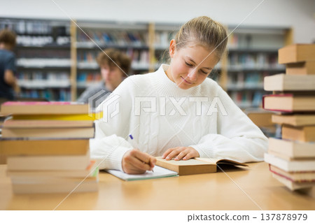 Girl preparing for exams in library 137878979