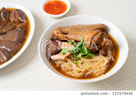 Braised duck noodles with brown soup 137879498