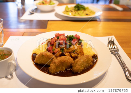 Omelet rice and croquettes - an image of a delicious lunch. Omelet rice and croquettes - an image of a delicious lunch. 137879765