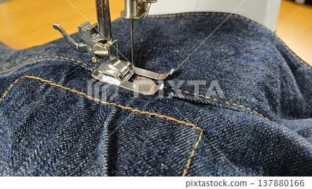 The hands of a senior man using a sewing machine 137880166