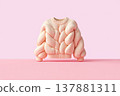 Pastel-pink chunky knit sweater on soft pink background, stylized product study 137881311