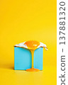 Sunny-side egg perched on a pastel blue rectangular block with golden yolk spill 137881320