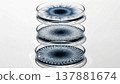 Three stacked petri dishes with blue radial growth patterns 137881674