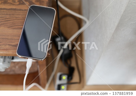 Smartphone charging with a power-saving tap Smartphone charging with a power-saving tap 137881959