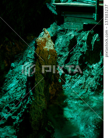 A cave with flowing water A cave with flowing water 137883237