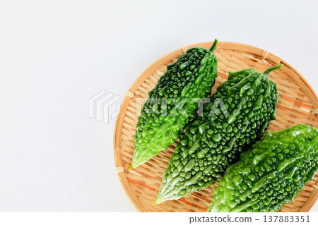 Summer vegetables: bitter melon (goya) - copy space Summer vegetables: bitter melon (goya) - copy space 137883351