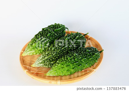 Summer vegetables: bitter melon (goya), white background, copy space. Summer vegetables: bitter melon (goya), white background, copy space. 137883476
