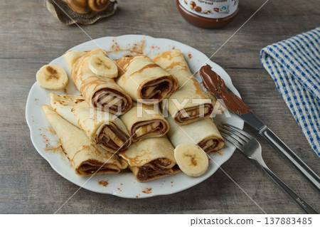 Sweet Crepes with Chocolate Spread and Banana 137883485