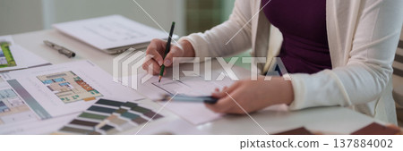 Asian Adult Woman Architect Designer Sketching Architectural Blueprints Creating Floor Plans Interior Designs Professional Project Development Work Office Workspace 137884002