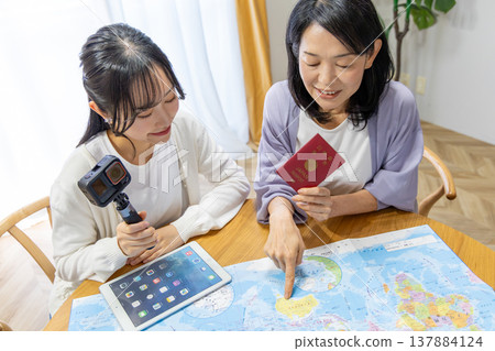 A mother and daughter planning an overseas trip A mother and daughter planning an overseas trip 137884124