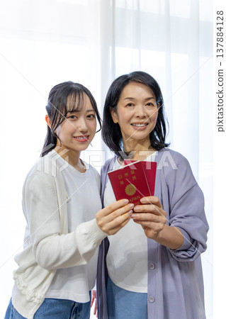 Mother and daughter with passports 137884128