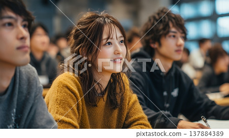 Female university student attending a lecture 137884389