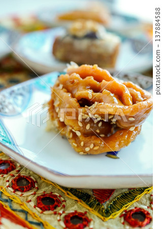 Chebakia, a traditional Moroccan sweet: a fried pastry made with honey and sesame seeds, a staple Ramadan treat. Close-up. Chebakia, a traditional Moroccan sweet: a fried pastry made with honey and sesame seeds, a staple Ramadan treat. Close-up. 137884588