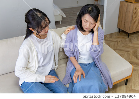 A mother who is unwell and her worried daughter A mother who is unwell and her worried daughter 137884904