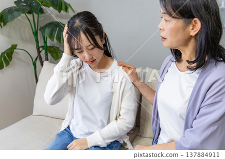 A daughter who is unwell and her worried mother A daughter who is unwell and her worried mother 137884911