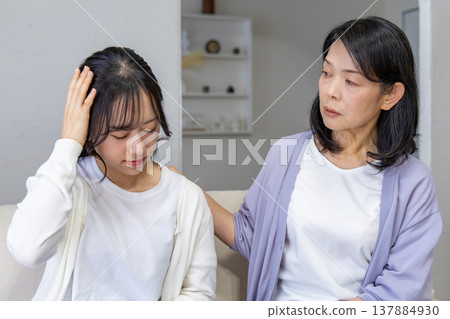 A mother worries about her daughter who is unwell. A mother worries about her daughter who is unwell. 137884930