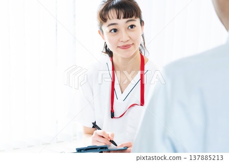 Healthcare worker explaining to patient Healthcare worker explaining to patient 137885213