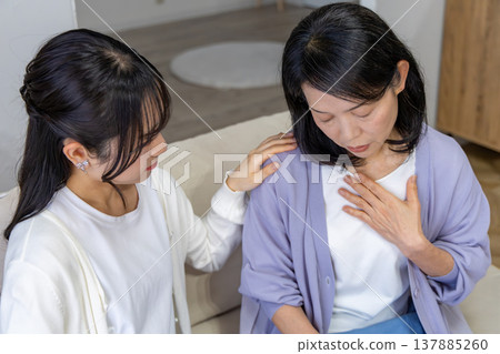 A mother who is unwell and her worried daughter 137885260