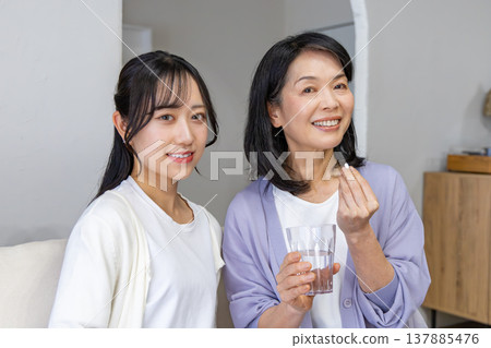 A mother and daughter taking medicine: Health image A mother and daughter taking medicine: Health image 137885476