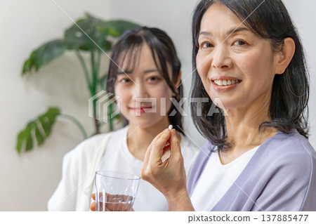 A mother and daughter taking medicine: Health image A mother and daughter taking medicine: Health image 137885477