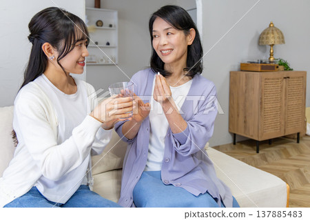 A mother and daughter taking medicine: Health image A mother and daughter taking medicine: Health image 137885483