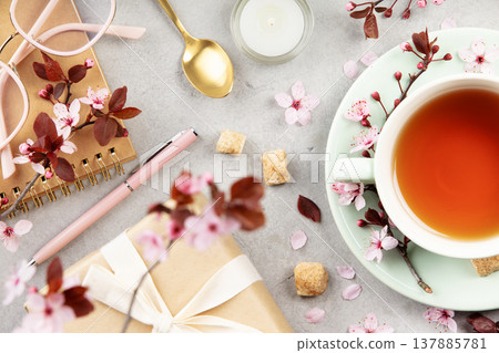 Spring Tea Flat Lay with Blossoms, Notebook, Gift and Glasses 137885781