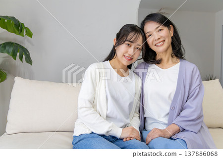 A close mother and daughter huddled together. A close mother and daughter huddled together. 137886068