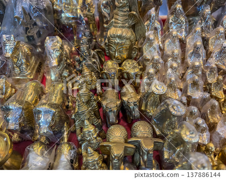 collection of small, shiny, metallic objects, likely made of brass or a similar material.  137886144
