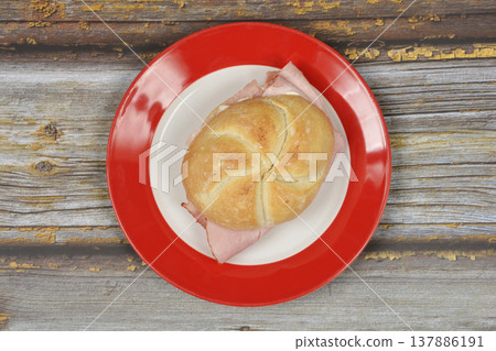 Ham Sandwich in a Kaiser Roll on a Red Plate Ham Sandwich in a Kaiser Roll on a Red Plate 137886191