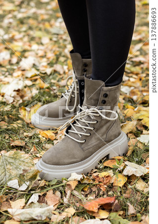 New collection of women's spring shoes. Slender female legs close-up in genuine leather boots. 137886693