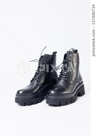 Women's black leather boots on a white background. Shoes and options for its layout. Autumn shoes. Boots. Autumn boots. Shoes close up Women's black leather boots on a white background. Shoes and options for its layout. Autumn shoes. Boots. Autumn boots. Shoes close up 137886734