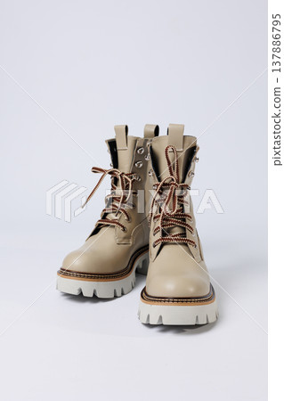 Beautiful beige shoes with genuine leather on an isolated white studio background. Fashionable classic women's boots. Stylish elegant leather shoes. Beautiful beige shoes with genuine leather on an isolated white studio background. Fashionable classic women's boots. Stylish elegant leather shoes. 137886795