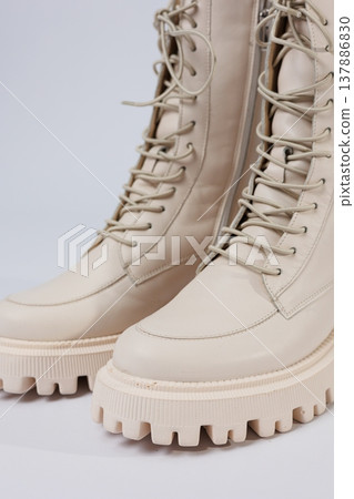 Women's white winter boots with fur with thick soles and laces. Advertising of the new collection of women's shoes 2022 137886830