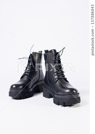 Women's black leather boots on a white background. Shoes and options for its layout. Autumn shoes. Boots. Autumn boots. Shoes close up 137886843
