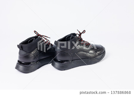 Leather black short men's autumn sneakers on a white background. Sneakers winter collection 2022. Leather black short men's autumn sneakers on a white background. Sneakers winter collection 2022. 137886868