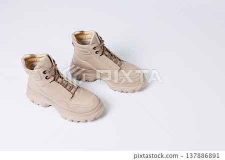 Beautiful shoes on an isolated white studio background. Fashionable beige women's shoe. Elegant stylish footwear. Beautiful shoes on an isolated white studio background. Fashionable beige women's shoe. Elegant stylish footwear. 137886891