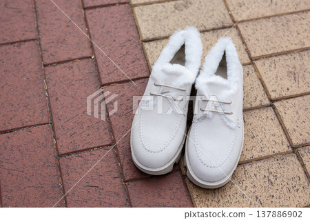 women's white leather shoes stand on a tile. Collection of autumn women's shoes women's white leather shoes stand on a tile. Collection of autumn women's shoes 137886902