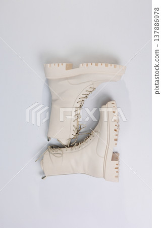 Women's white winter boots with fur with thick soles and laces. Advertising of the new collection of women's shoes 2022 137886978