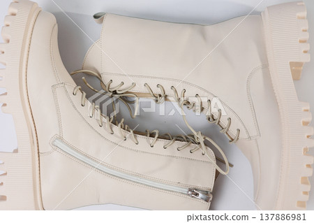 Women's white winter boots with fur with thick soles and laces. Advertising of the new collection of women's shoes 2022 137886981