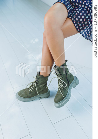 Close-up of comfortable women's boots made of genuine leather. New collection of winter shoes for stylish girls. Fashionable women's stylish leather boots. Close-up of comfortable women's boots made of genuine leather. New collection of winter shoes for stylish girls. Fashionable women's stylish leather boots. 137886995