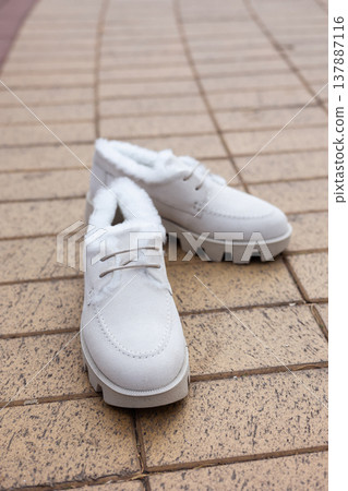 women's white leather shoes stand on a tile. Collection of autumn women's shoes women's white leather shoes stand on a tile. Collection of autumn women's shoes 137887116