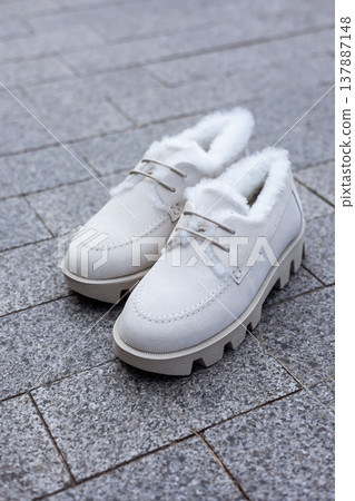 women's white leather shoes stand on a tile. Collection of autumn women's shoes women's white leather shoes stand on a tile. Collection of autumn women's shoes 137887148