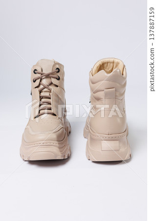 Beautiful shoes on an isolated white studio background. Fashionable beige women's shoe. Elegant stylish footwear. Beautiful shoes on an isolated white studio background. Fashionable beige women's shoe. Elegant stylish footwear. 137887159